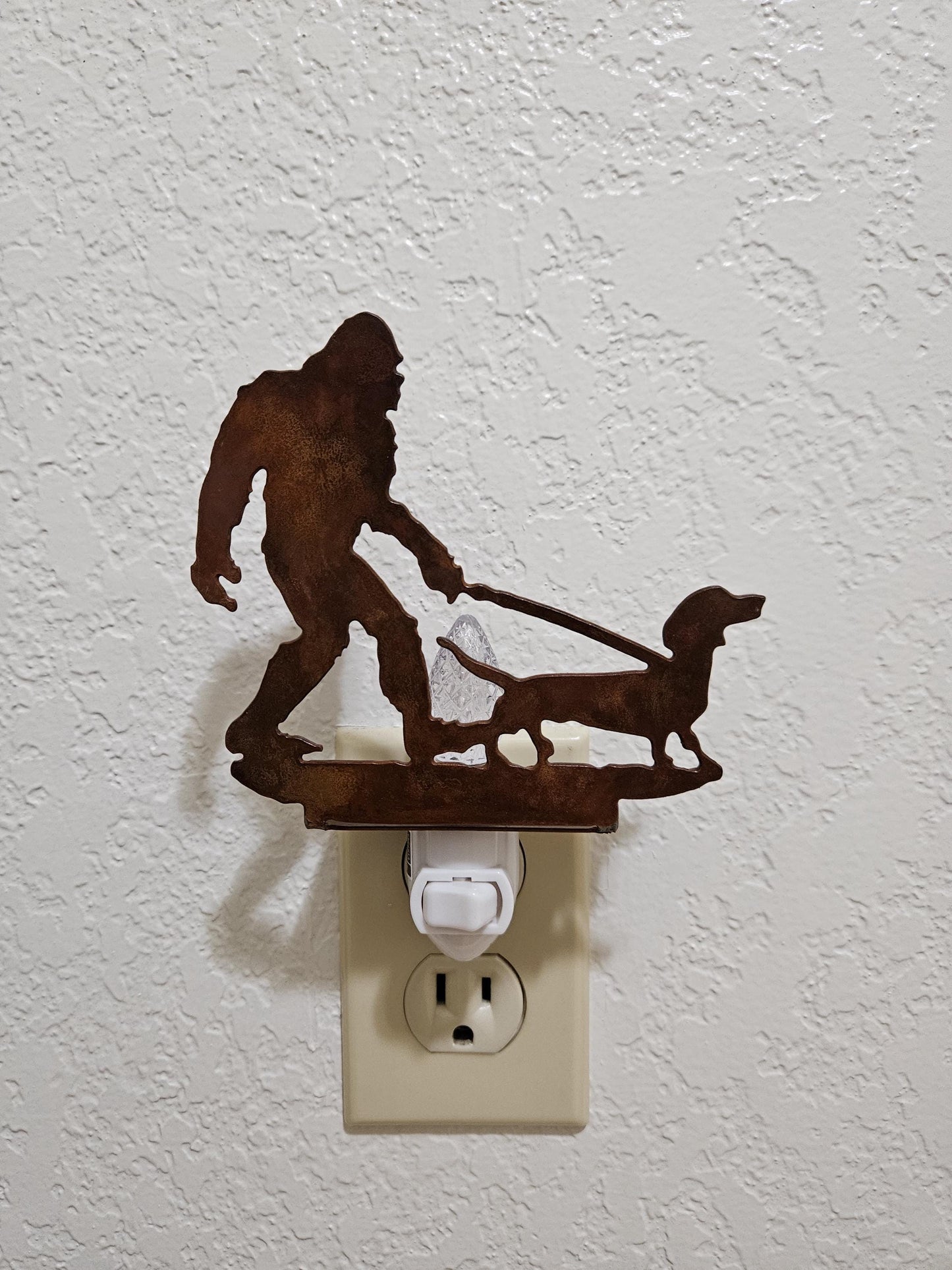 Bigfoot walking a Dachshund as a Night Light- made from smooth, durable rustic metal