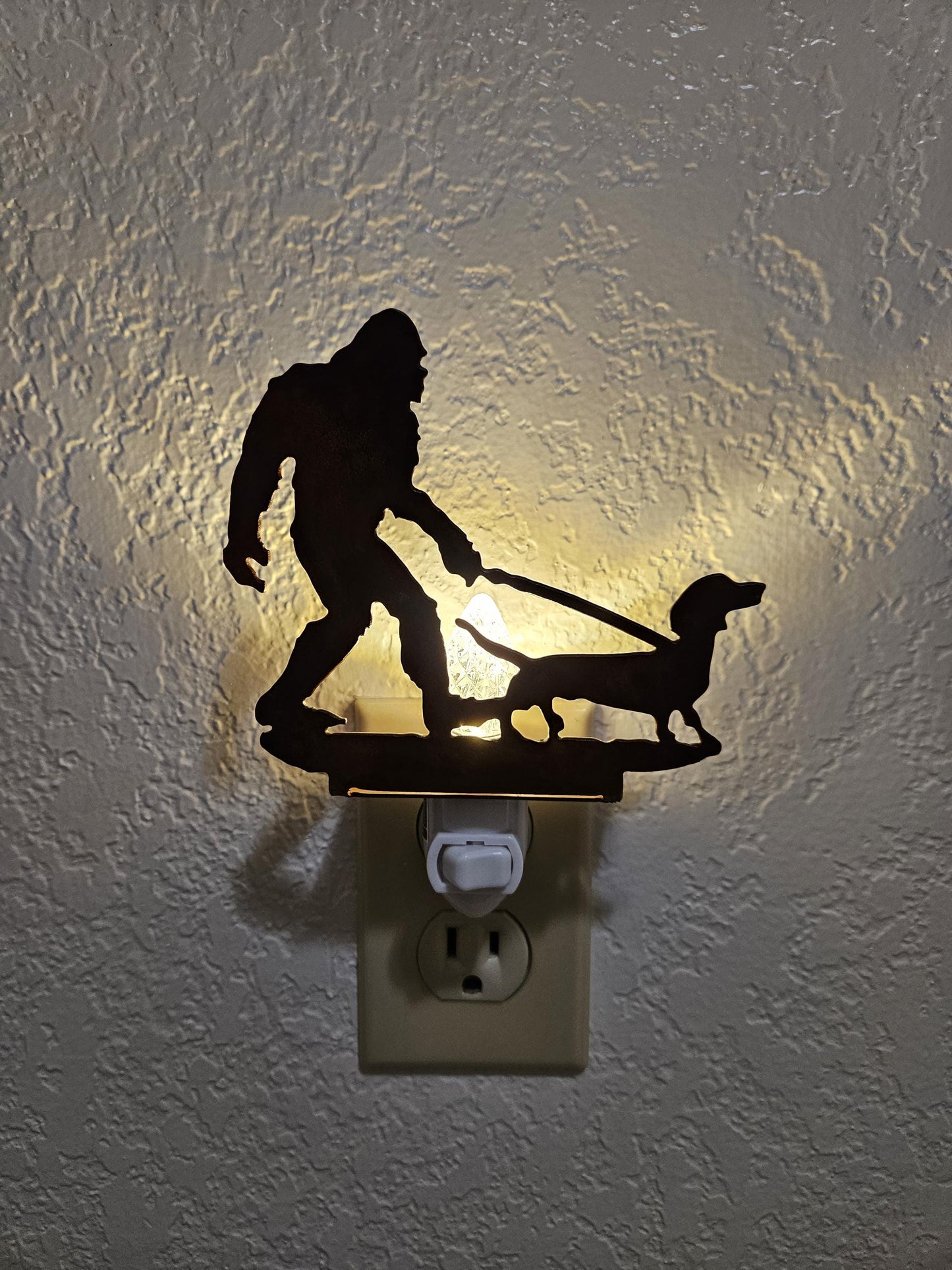 Bigfoot walking a Dachshund as a Night Light- made from smooth, durable rustic metal