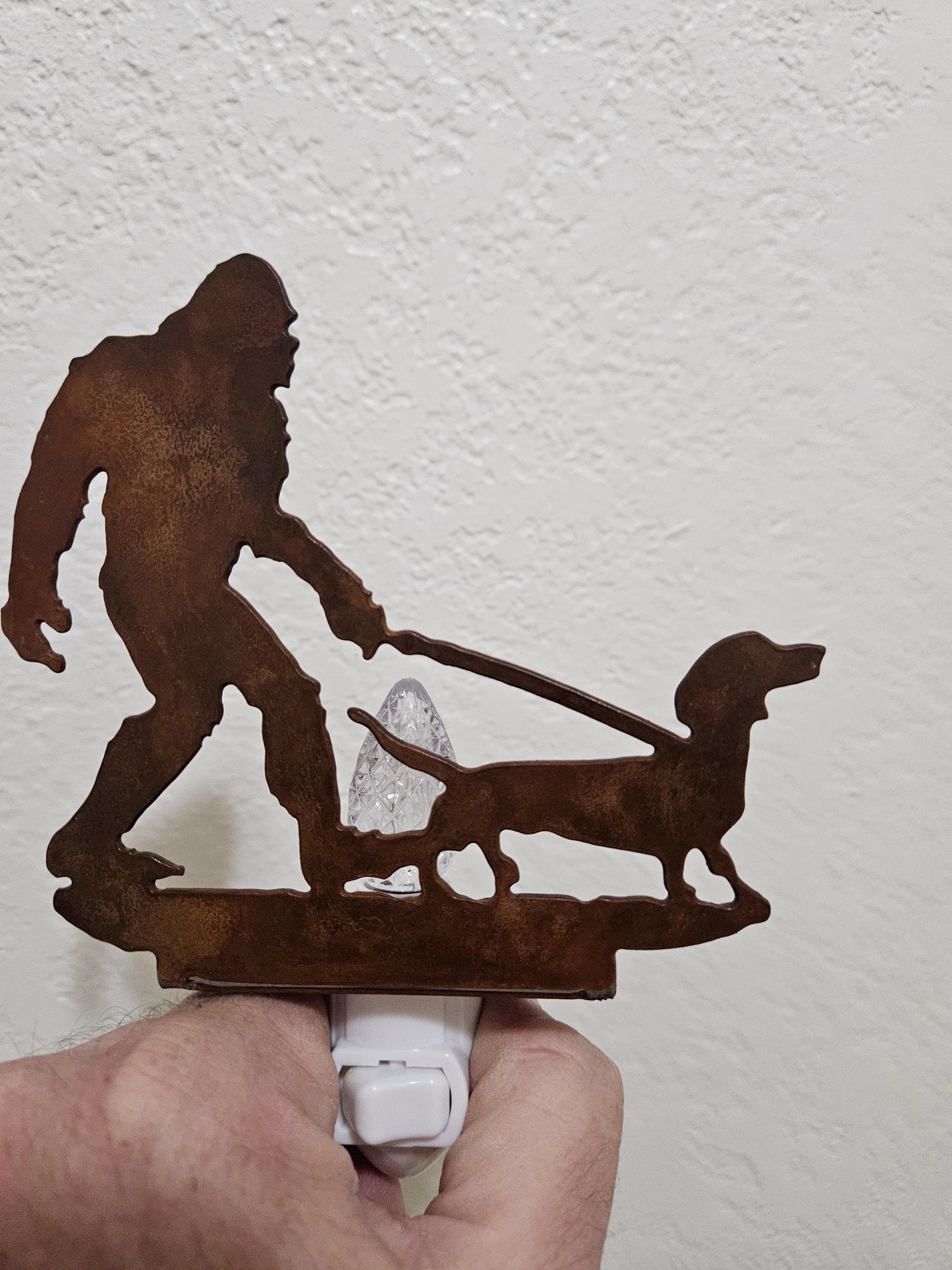 Bigfoot walking a Dachshund as a Night Light- made from smooth, durable rustic metal