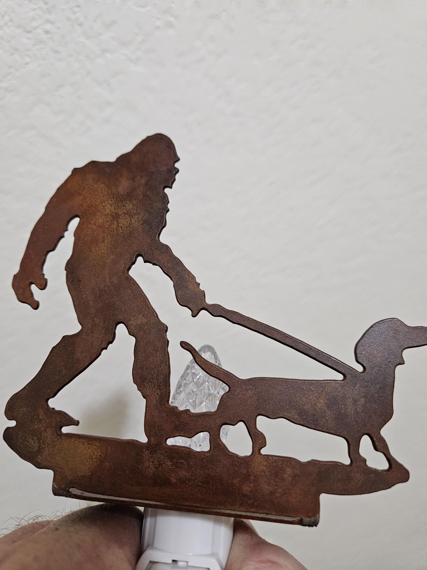 Bigfoot walking a Dachshund as a Night Light- made from smooth, durable rustic metal